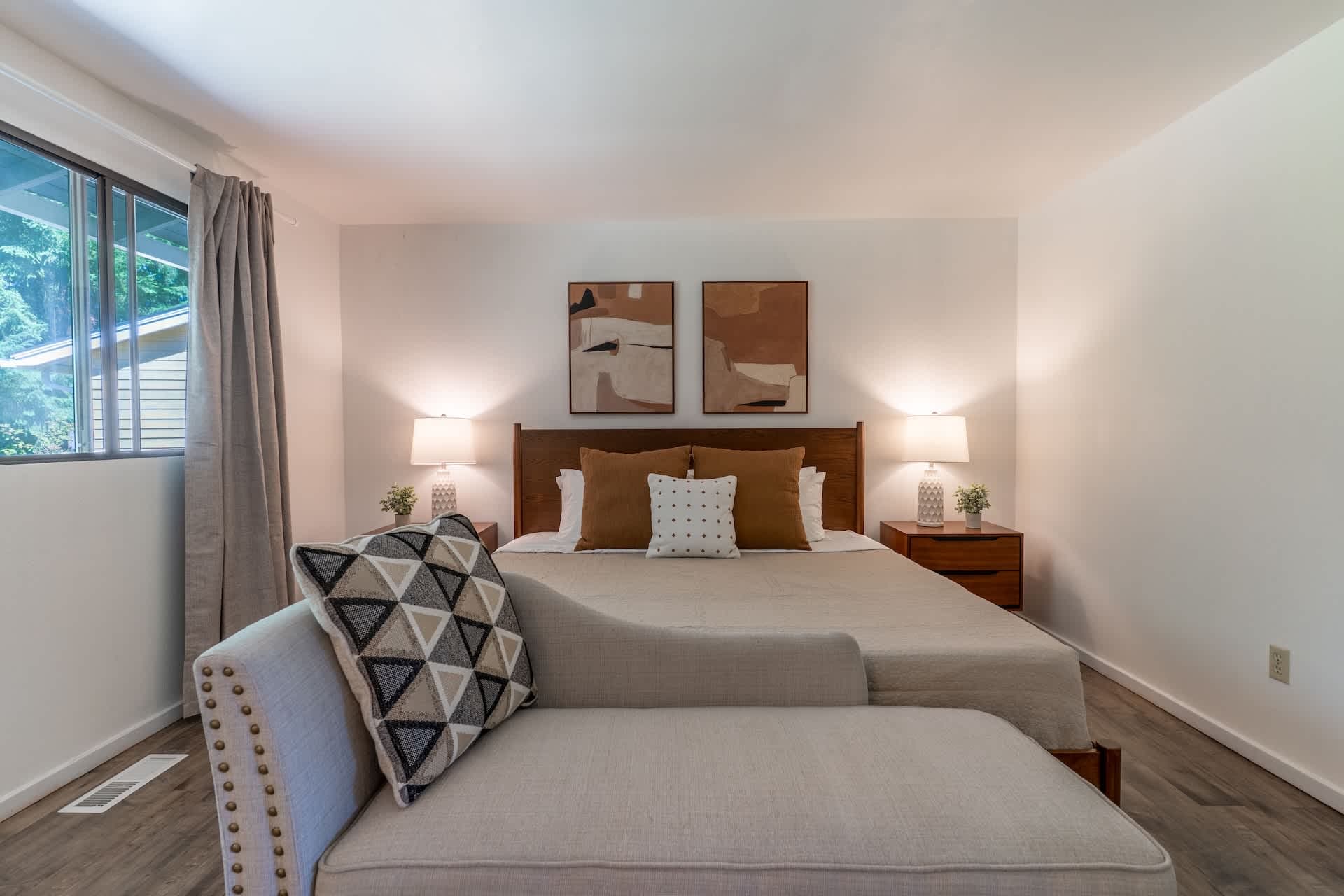 Relax in comfort with a king-size bed, warm natural light, and a serene atmosphere.