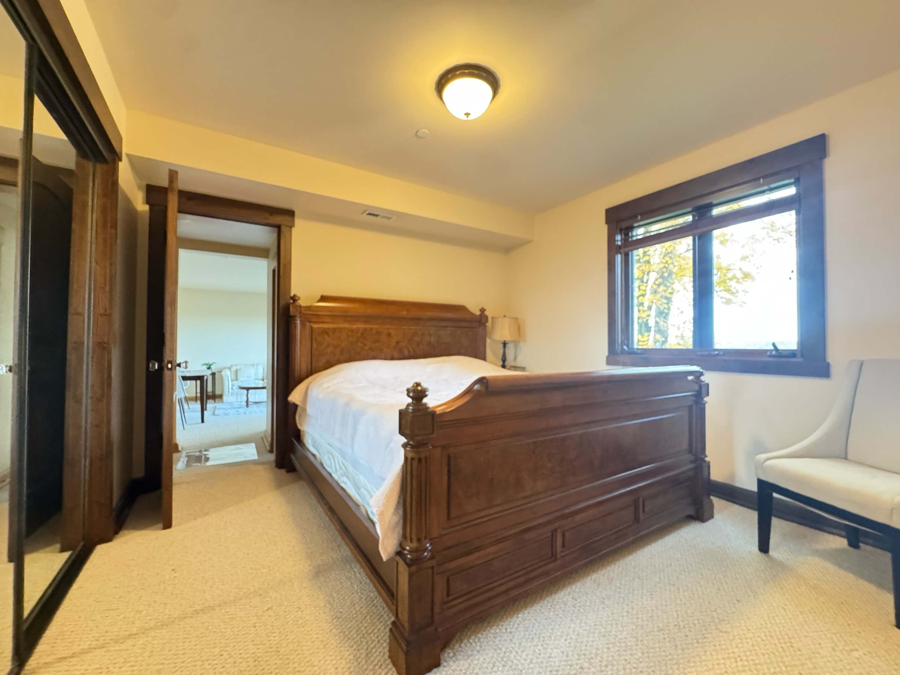 Retreat into the peaceful embrace of the richly furnished, sunlit bedroom.
