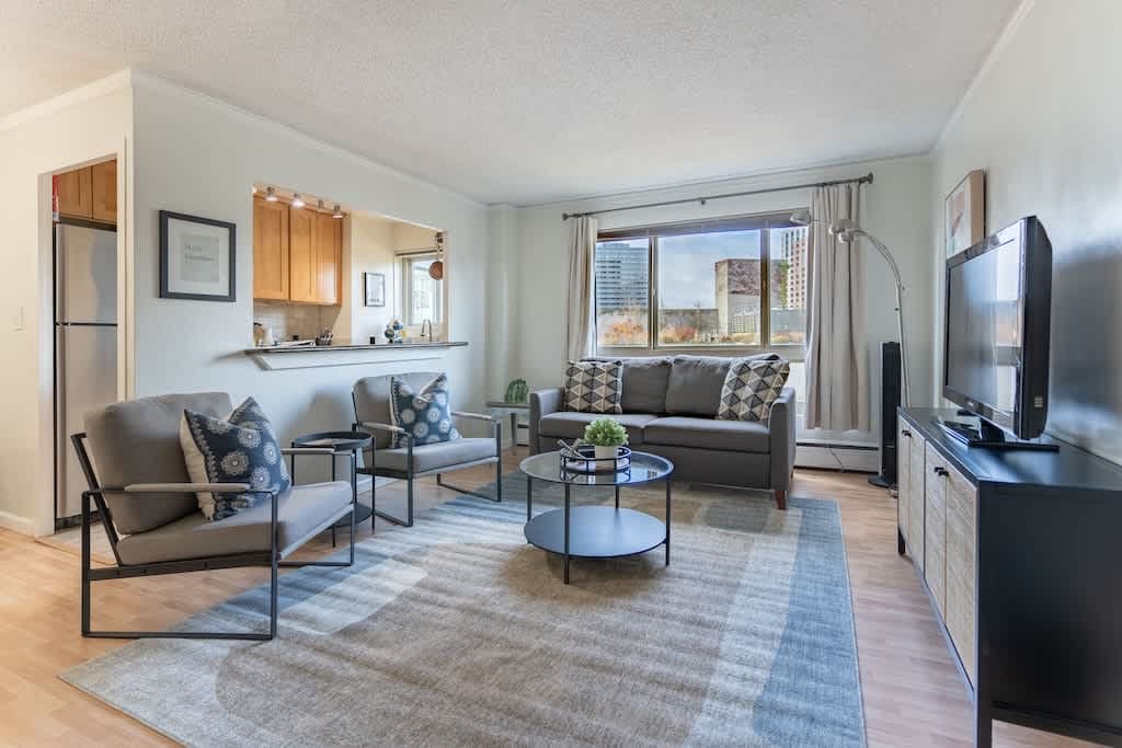 A warm glow fills the spacious living room, beckoning you to relax and unwind in comfort.