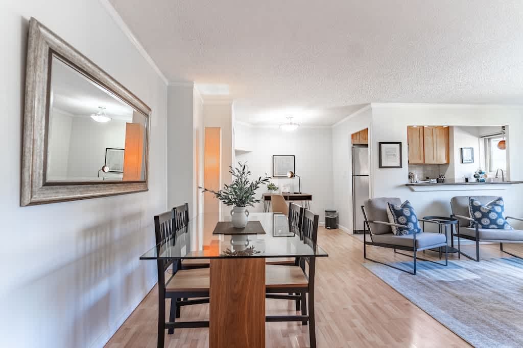 Elegant and modern, this glass dining table seats four, offering a sleek space for intimate meals and conversation.