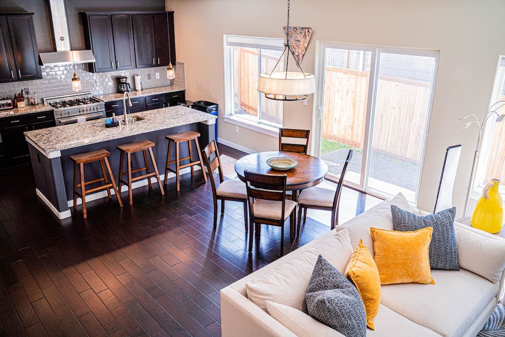 Experience seamless living in this open-concept dining and sala area, where cozy seating and a stylish dining setup come together under warm lighting and abundant natural sunlight.