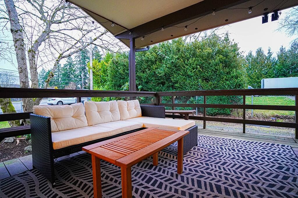 The covered deck serves as a private outdoor haven for unwinding after a day of