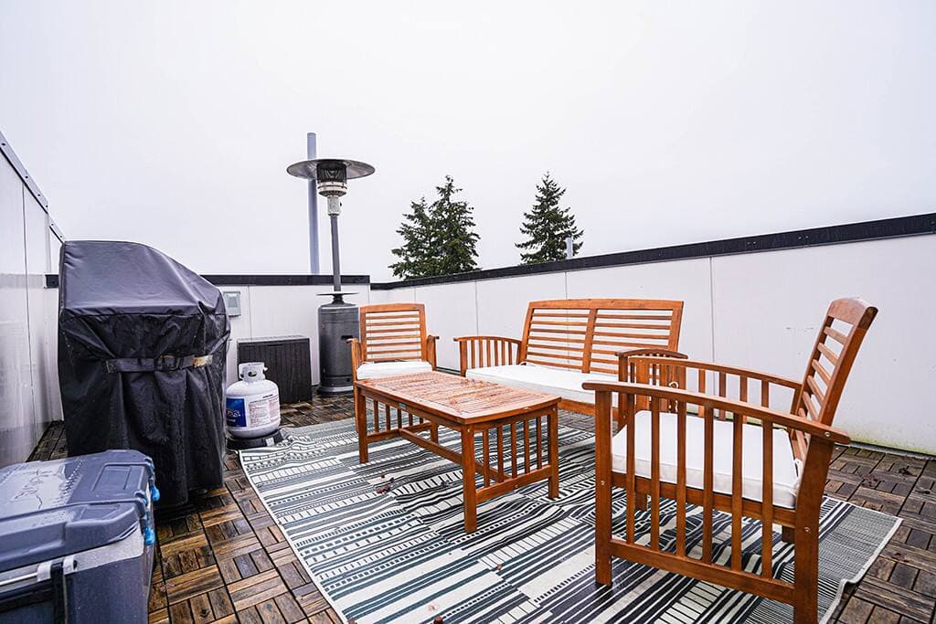 The private rooftop deck that is the perfect spot to enjoy a breath of fresh air and spectacular views of the mountains, and Seattle skyline