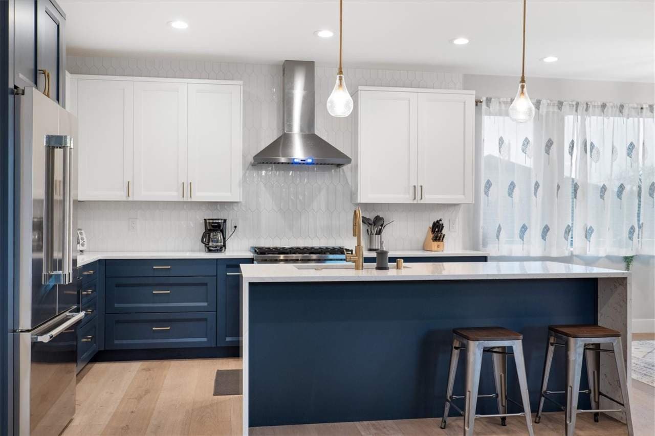 Kitchen perfection meets modern design, blending sleek finishes and bold cabinetry with a space made for cooking, eating, and connecting.