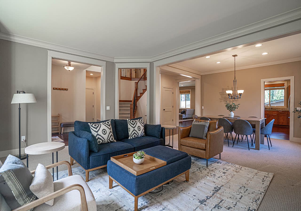 Spacious living room boasts large windows that flood the space with natural light, elegant recessed lighting, and a seamless flow into the kitchen and dining areas—perfect for both everyday living and entertaining.