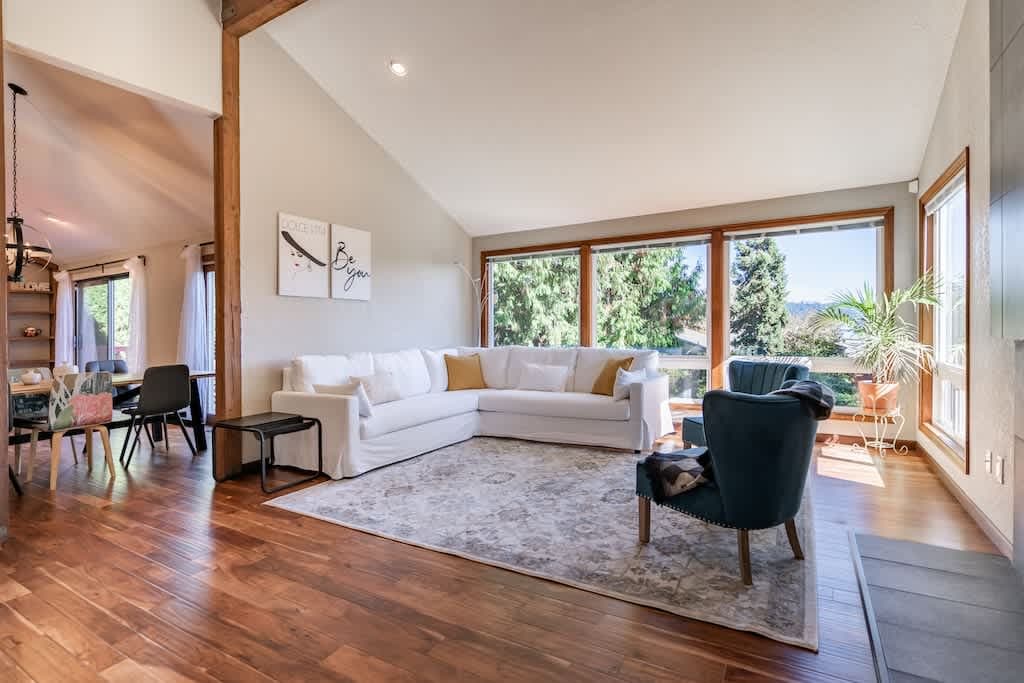 Bright and spacious living room with huge windows, comfy seating, and peaceful views. Perfect for relaxing or gathering with friends.