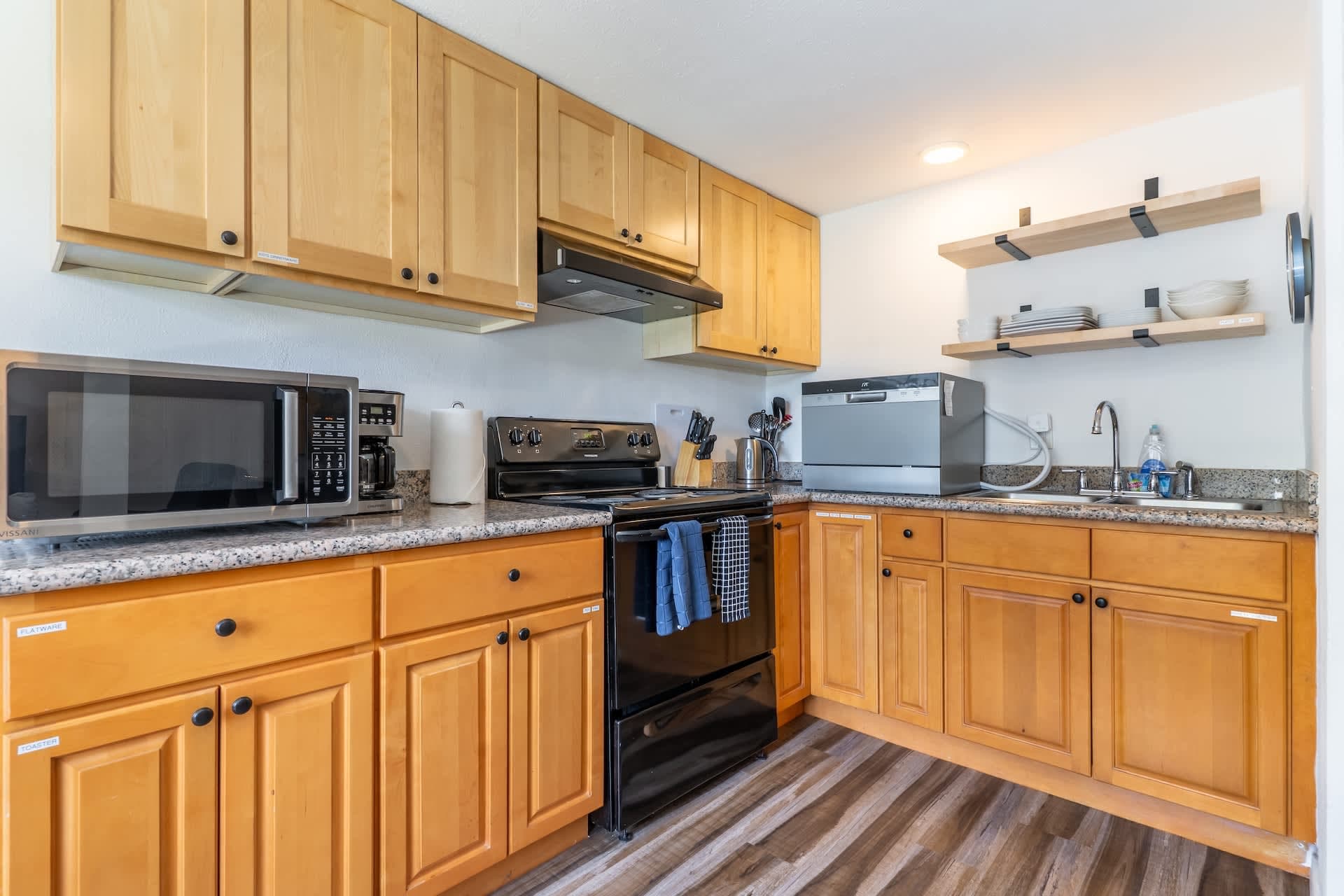 Functional and bright kitchen equipped with wooden cabinetry, modern appliances, and ample countertop space.